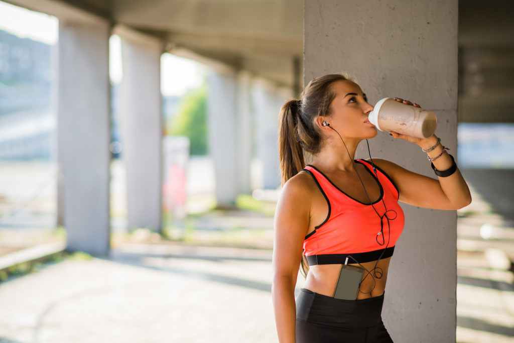 woman drinking after cardio