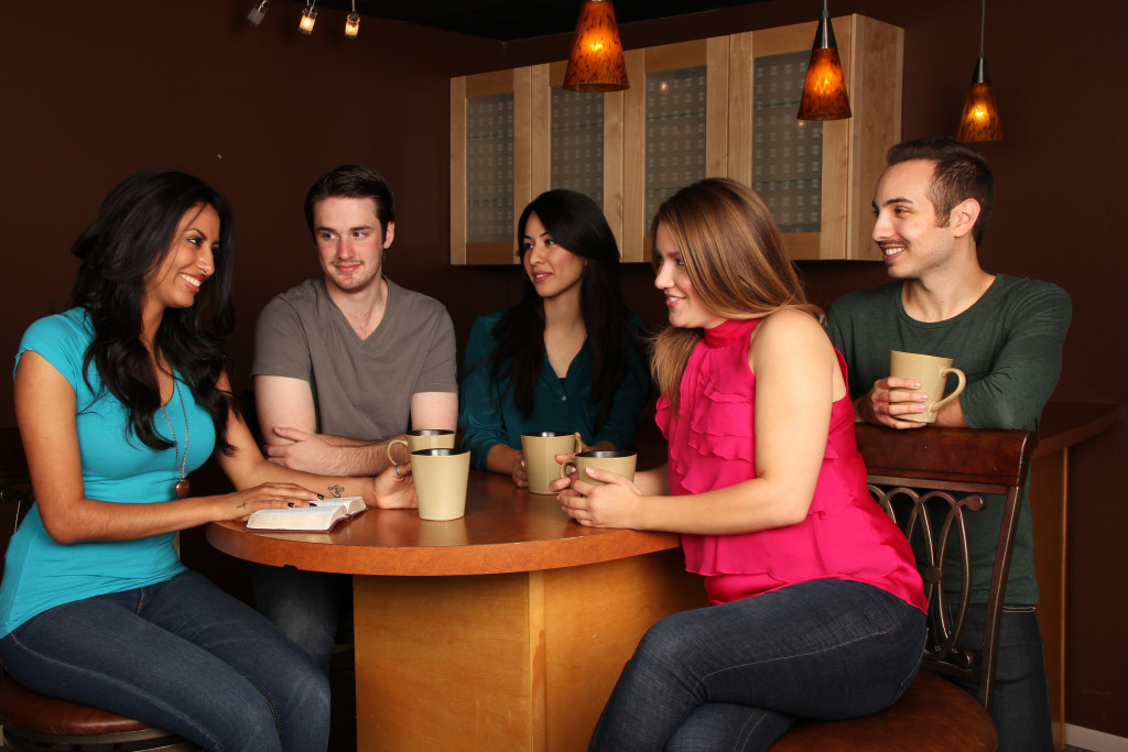Diverse Group of Friends Bible Study in Cafe