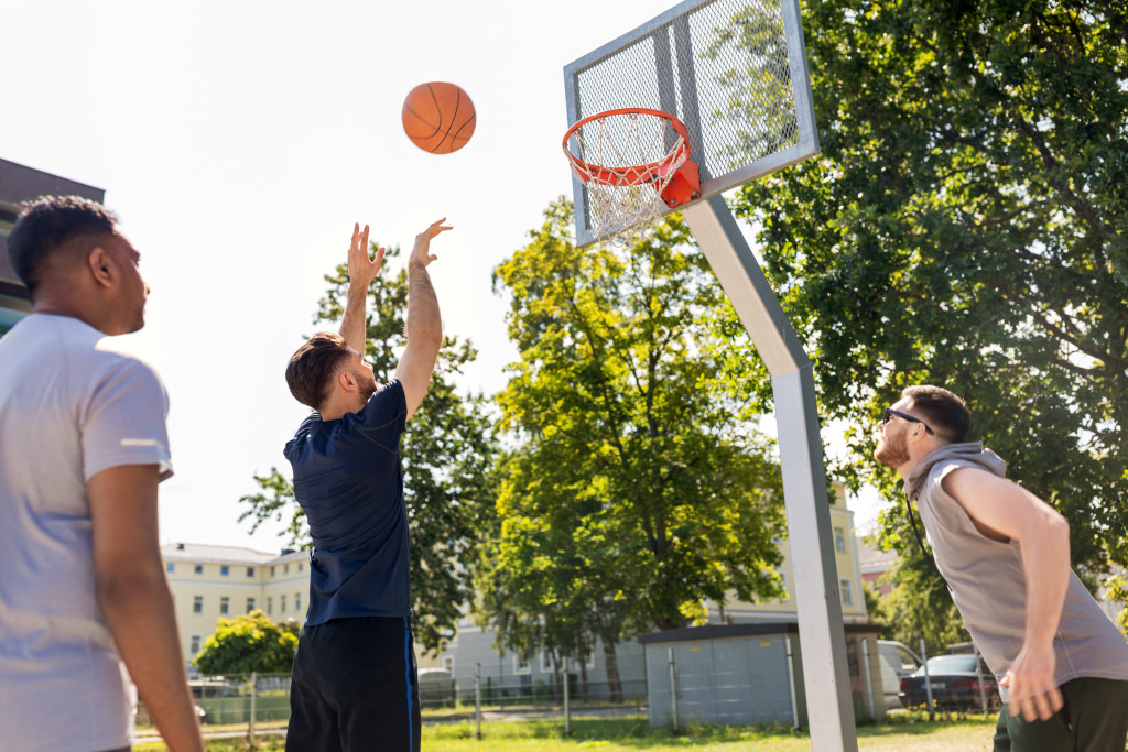 friends outdoor playing basketball