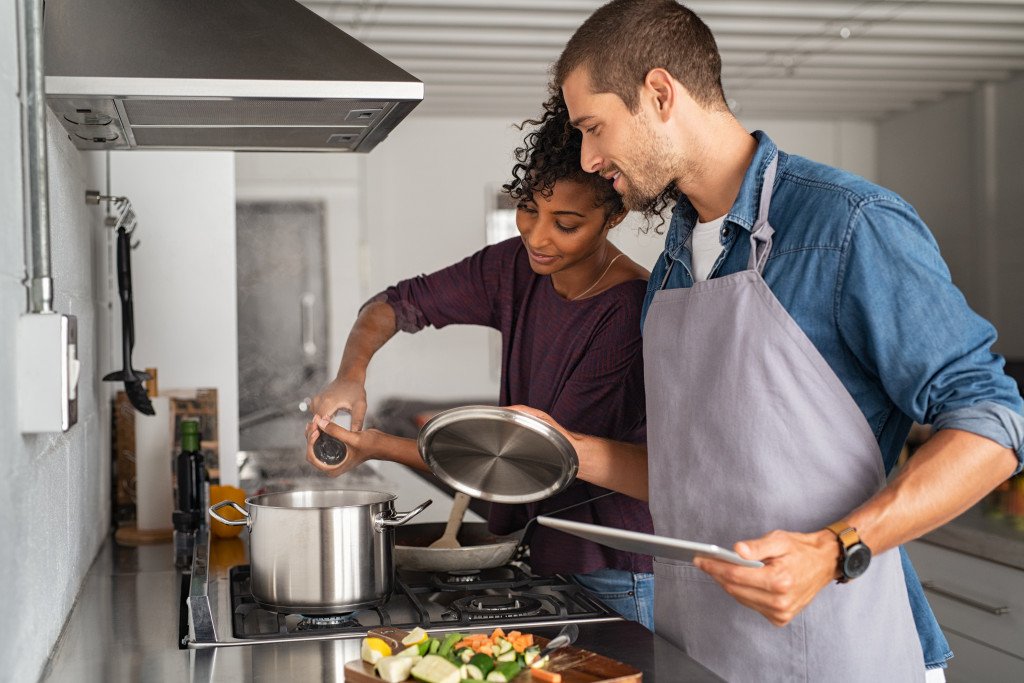 A couple cooking together in their kitchen