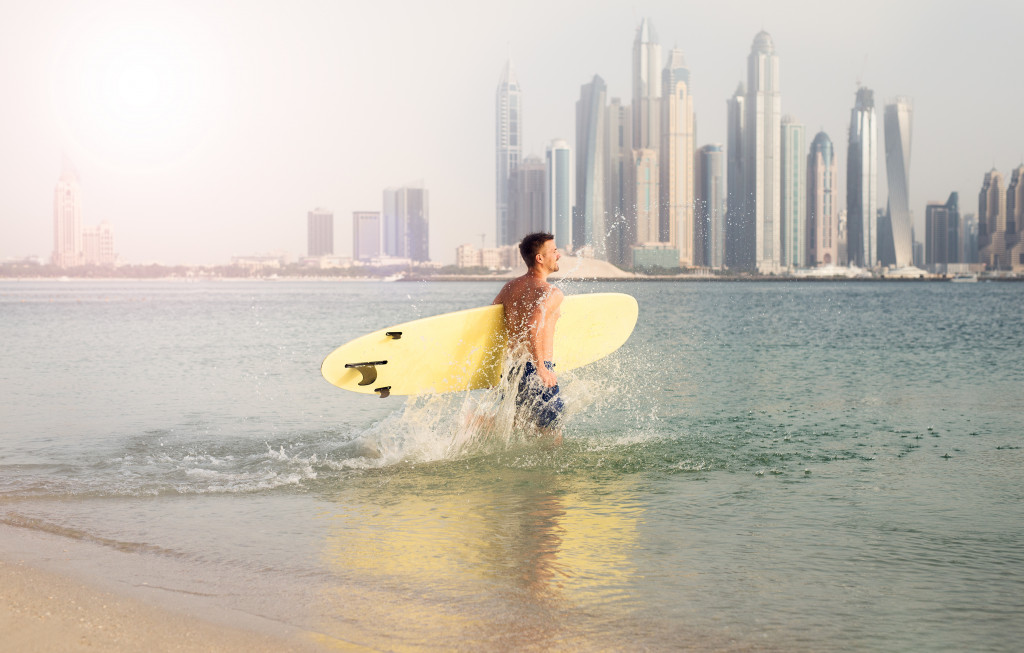 man going surfing